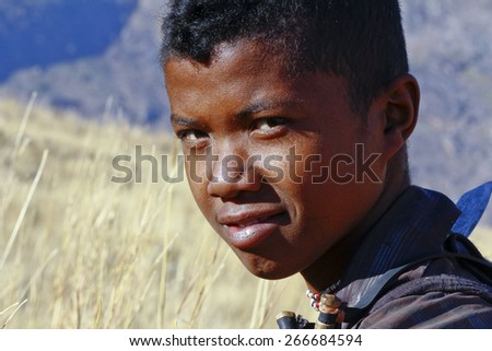 Portrait of adorable young happy boy - african poor child, poverty