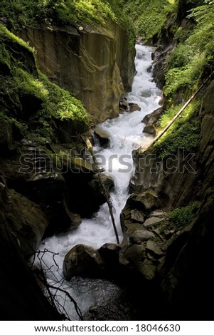 Little waterfall - water well - hidden in forest shadows, Austrian Alps