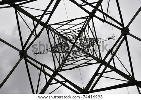Electric power utility pole on cloudy sky,low angle view