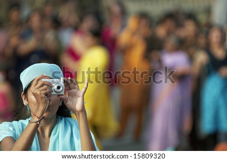 WAGAH BORDER POST, INDIA - JULY 24: Unidentified Indian lady taking photographs of the ceremony closing the border between India and Pakistan. July 24, 2008 in Wagah, Punjab, India