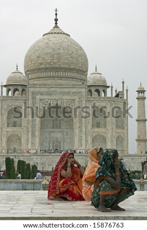 AGRA, INDIA - JULY 26: Unidentified Indian ladies in colorful sari\'s squatting on a white marble plinth at the Taj Mahal July 26, 2008 in Agra, Uttar Pradesh, India