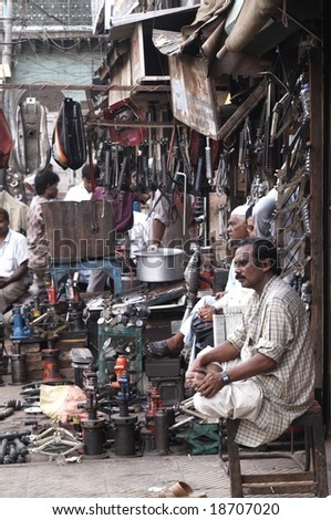 DELHI - SEPTEMBER 18: Indian man outside a shop selling car parts. September 18 2006 in Old Delhi, India