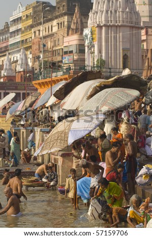 VARANASI, INDIA - 11 OCTOBER: Crowds of people bathing in the sacred River Ganges on October 11, 2007 in the sacred city of Varanasi, Uttar Pradesh, India