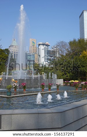 HONG KONG, CHINA - FEBRUARY 1: Fountains in Hong Kong Botanical Gardens surrounded by tall office buildings on February 1, 2012 in Hong Kong, China.