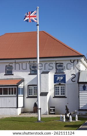 STANLEY, FALKLAND ISLANDS - FEBRUARY 9, 2015: Royal Falkland Islands Police Headquarters in Stanley, capital of the Falkland Islands. White painted building with red corrugated iron roof.
