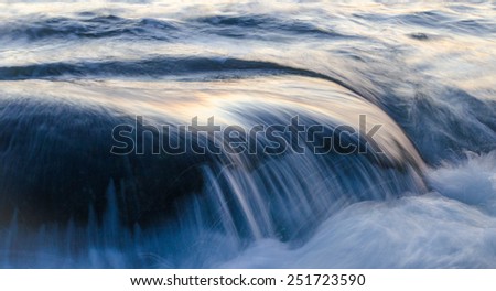 Sea water flowing over rock