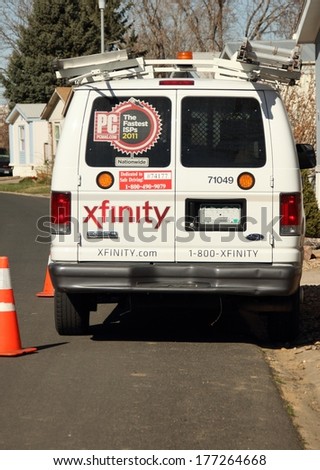 WESTMINSTER, COLORADO/U.S.A. - MARCH 20, 2013: Xfinity Comcast van outside of a customers home, the van is parked on the street. The back of the van has logos and caution cones.