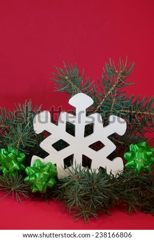 Bows and Snowflake Wooden snowflake surrounded by green bows and fresh cut pine.