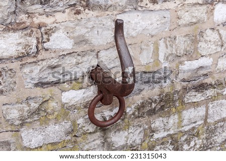 Nice brown old metal hook in wall at berth