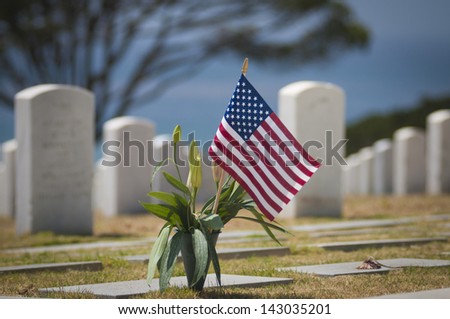 US Flag Flies over military cemetery