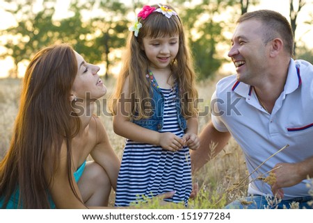 Portrait of young parents with their four-year old daughter
