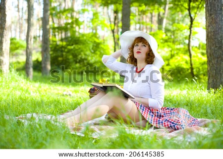 Romantic young pin-up girl resting in the forest