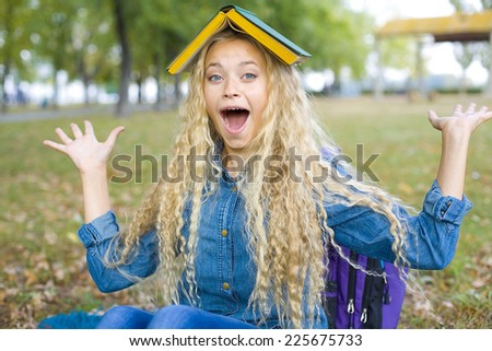 Humorous portrait of girl students in the park