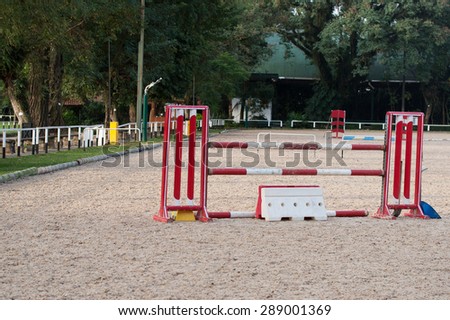 Horse riding club obstacles and sticks in sandy terrain