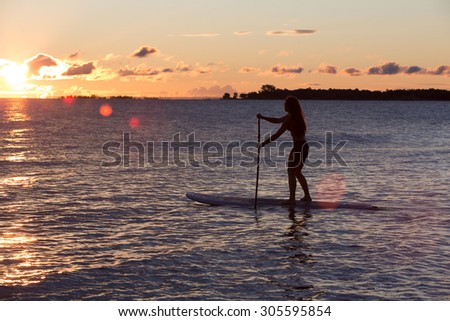 Attractive Young Woman Stand Up Paddle Boarding, Active Beach Lifestyle
