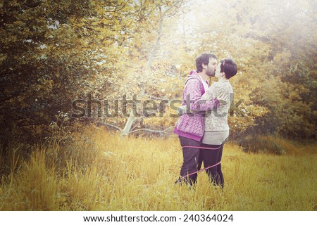 young love couple man and woman on walk with dog in autumn nature