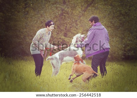 young love couple man and woman on walk with dog in autumn nature