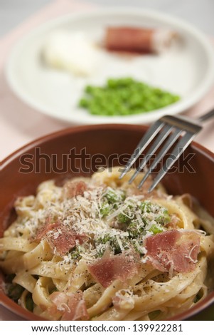Fettuccine papalina, Dish of traditional Roman cuisine, pasta with peas ham onion eggs