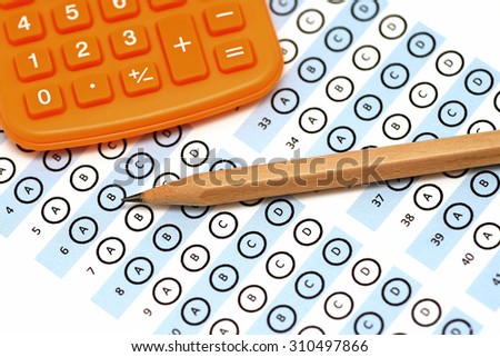 answer sheet test score with pencil and calculator