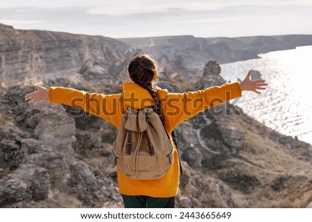 Image, Stock Photo Woman on stony seashore looking on foamy water washing peaks