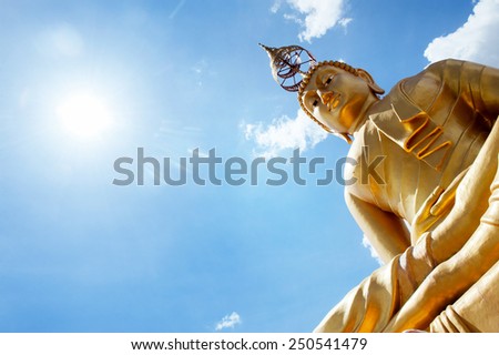Statue of Thailand sitting Buddha on background of blue sky