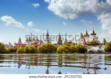 Beautiful russian landscape of Izmailovsky kremlin with pond against cloudy sky backdrop. Moscow city, Russia. Summer photo