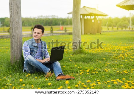 a man with a laptop on nature