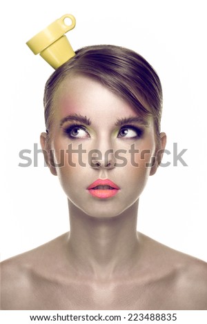 Young Pretty Blonde Woman Holding Coffee Cup on her Head