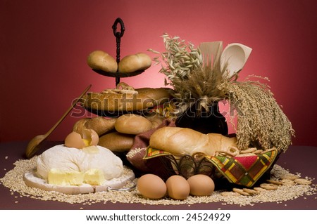 Domestic still life with bread food, dough, cereals,grains, butter, eggs and spoons.