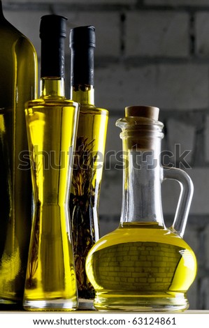 Olive oil bottle still-life over grey brick background