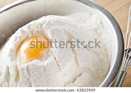 Wheat  white flour  with  egg yolk in cooking bowl