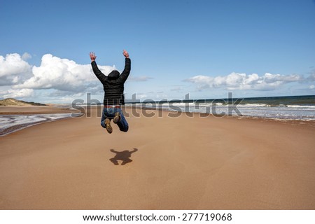 Man jumping for joy on the beach