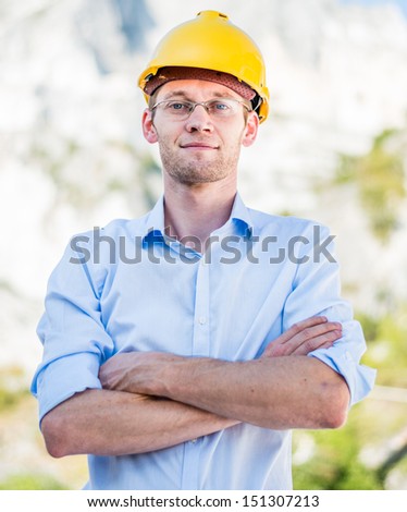 Portrait of happy young foreman with hard hat