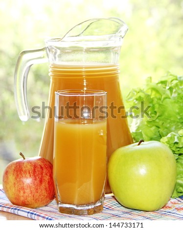 Apple juice and two colorful fresh apples