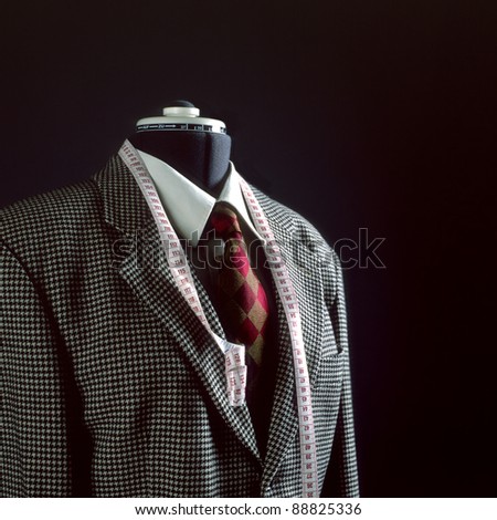 The image shows a dress form with a jacket, a shirt and a cravat