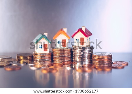 Miniature colorful house on stack coins using as property and financial concept