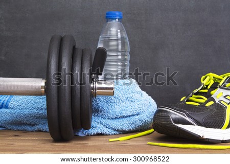 Dumbbell, water bottle, towel and running shoes