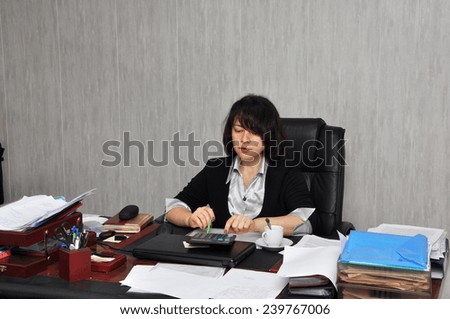 Beautiful executive woman working with documents in the office
