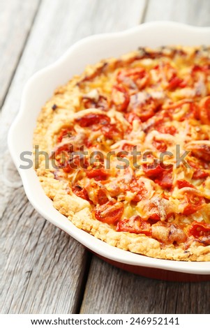 Fresh tomato pie on grey wooden background