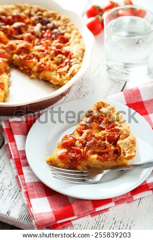 Fresh tomato pie on white wooden background