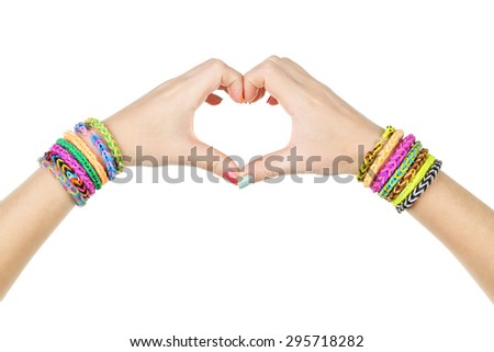 Female hands in shape of heart with colorful rubber band bracelets