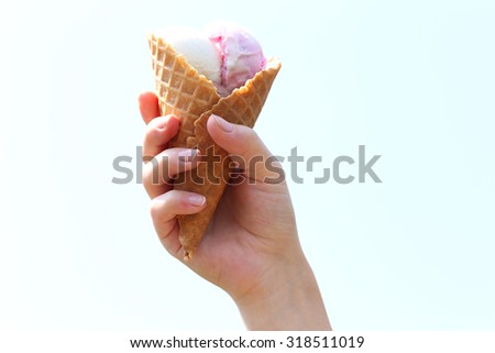 Woman hand holding waffle with ice cream