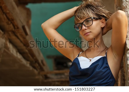 Portrait of a beautiful young woman, shot in the destroyed house.