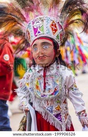 PISAC, PERU - JULY 16, 2013: masked kid dancer at Virgen del Carmen parade
