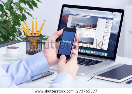 Facebook app on the Apple iPhone display and desktop version of Facebook on the Apple Macbook Pro Retina. Multi devices multitasking concept. All gadgets in full focus. Varna, Bulgaria - May 29, 2015.