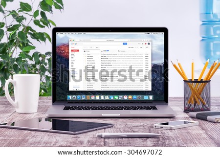 Office workplace with open Apple Macbook Pro Retina with Google Gmail web page on the display. Gmail is a most popular free Internet e-mail service provided by Google. Varna, Bulgaria - May 31, 2015.
