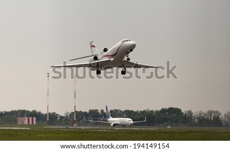 Borispol, Ukraine - May 18, 2014: International Jet Management Dassault Falcon 900EX aircraft departing in the rainy day from the Borispol International Airport on May 18, 2014. Editorial use only