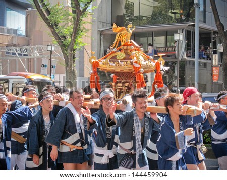 TOKYO, JAPAN - SEPTEMBER 18: Golden portable shrine Festival on September 18, 2011 in Tokyo, Japan. This is the famous festival in summer of Japan.