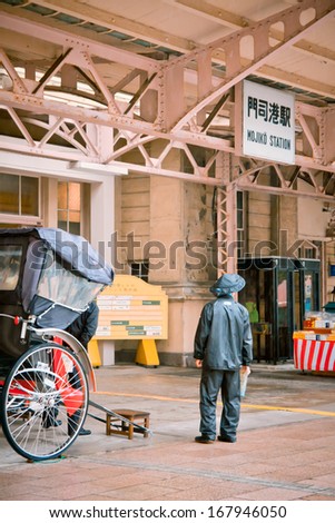 KITAKYUSHU, JAPAN - October 30: One of local cart riders is waiting for the passenger in front of Mojoko train station on October 30, 2011 in Kitakyushu, Japan
