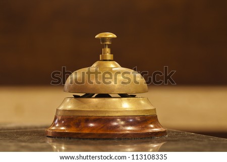 old hotel bell on a wood stand